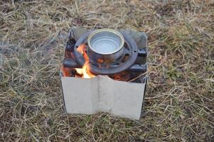 Metal stove for burning wood chips and firewood photo