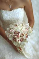 Close up of a bride holding a flower wedding bouquet photo