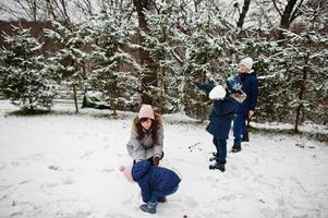 Attractive mother with her four kids in winter day. photo