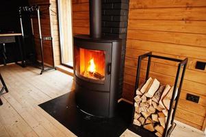 Fireplace with woods in modern wooden house. photo