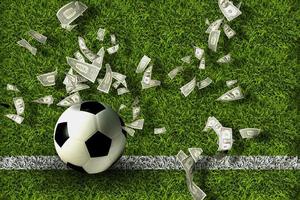 Soccer ball on green grass with dollar bills. Gambling ideas. photo