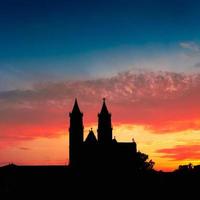 Silhouette of Cathedral of Magdeburg during bloody red sunset at Spring in Magdeburg, Germany, postcard photo