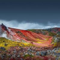 Landscape view of colorful rainbow volcanic Landmannalaugar mountains and famous Laugavegur hiking trail, with dramatic sky and snow in Iceland, summer photo