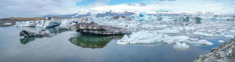 Panoramic view of Glacier Lagoon Jokulsarlon with icebergs and Vatnajokull Glacier tongue, Iceland, summer, with a touristic tour boat and people. photo