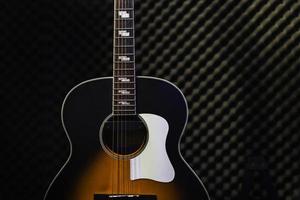 Acoustic guitar standing in the recording studio photo