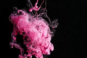 Pink colorful ink drop in water, Ink swirling in. abstraction image for background or color referent. photo