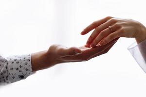 Concept of human relation, community, togetherness, teamwork, love, symbolism, culture and history. Hand of male and female reaching to each other. white background. Selective focus. photo