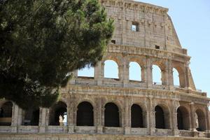 Rome, The Majestic Coliseum. Italy. Colosseum Rome. Ruins of the ancient Roman amphitheatre. Travel to Italy, Crowd and queue. Sunny day and blue sky photo