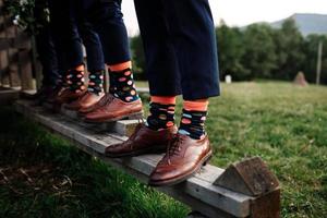 stylish men's socks. Stylish suitcase, men's legs, multicolored socks and new shoes. Concept of style, fashion, beauty and vacation photo