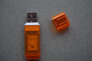 Orange usb flash card on gray background photo