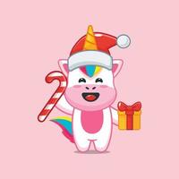 lindo personaje de dibujos animados de unicornio con dulces de navidad y regalo vector