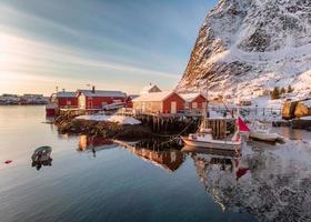 Fishing village with port in winter valley at sunrise morning
