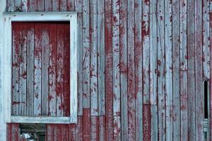 Weathered red wooden wall with window photo