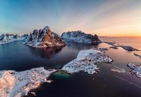 el amanecer en la isla de lofoten es un archipiélago con un pueblo de pescadores en la costa en invierno en noruega foto