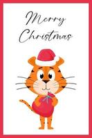 A cute cartoon tiger in a Santa Claus hat stands and holds a red bag with gifts. A greeting card with the inscription Merry Christmas. Color vector illustration isolated on a white background.