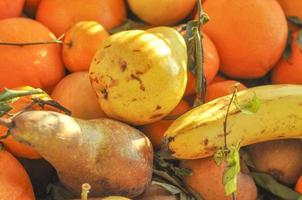 Many different fruits including pear orange banana photo