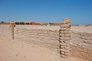 Brick fence wall at sand on Egypt photo