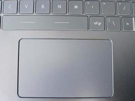 close up of a laptop keyboard touchpad for background. technology and business concept photo