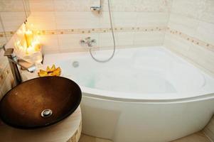 Modern washbasin in bathroom with burning candles photo