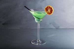 Close up single view of Green margarita with salt and sliced lemon from studio. Includes copy space. photo