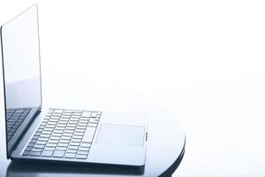 Profile side view of a laptop over white with backlit illumination. Includes copy space. photo