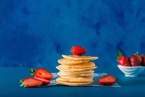 Closeup detail view of pancake stack with strawberry. Includes copy space. photo