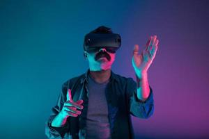 Turkish man is experiencing virtual reality, he is navigating and flipping the pages. photo