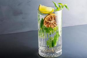 Closeup detail view of a glass of mojito in studio photo