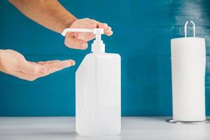 An anonymous hand is pushing down hand sanitiser, hygiene concept copy space includes. photo