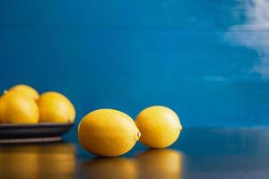 Moody styled pears view over rustic blue background with copy space. photo