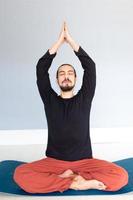 Man in peace with calm mood in meditation trance. Includes copy space, interior shot with professional performer. photo