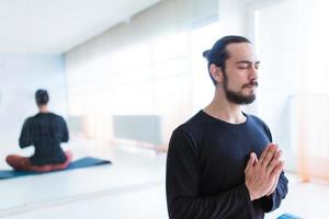 Man in peace with calm mood in meditation trance. Includes copy space, interior shot with professional performer. photo