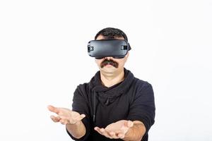 Man holding an invisible item in cyber realm during virtual reality experience. photo