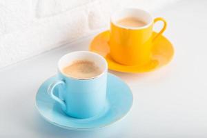 Colorful cups of Turkish coffee view over white studio. Minimal style with copy space. photo