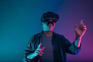 Turkish man is experiencing virtual reality, he is navigating and flipping the pages. photo