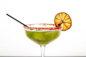 Close up single view of Green margarita with salt and sliced lemon from studio. Includes copy space. photo