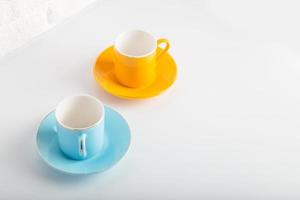 Colorful cups of Turkish coffee view over white studio. Minimal style with copy space. photo