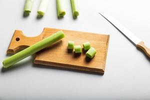 Minimal looking leeks view during slice progress over white, indludes copy space. photo