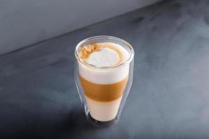 Perfectly gradient latte macchiato view over grey backdrop with copy space. photo
