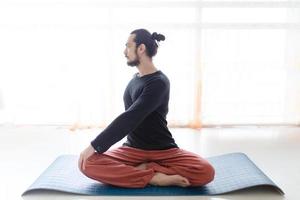 Man in peace with calm mood in meditation trance. Includes copy space, interior shot with professional performer. photo