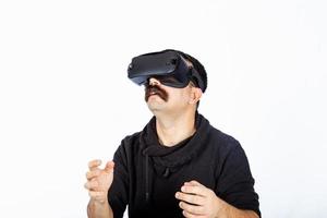 Man holding an invisible item in cyber realm during virtual reality experience. photo