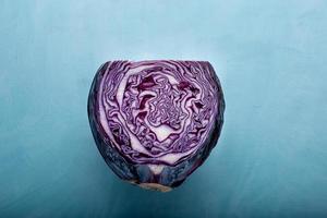 Flat lay view of purple cabbage over blue backdrop photo