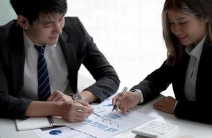 Business people meeting to find analytical ideas pointing to the graph at the office. photo