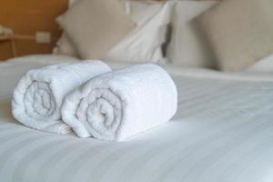 white towel on bed in bedroom photo