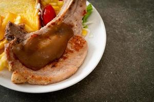 pork chop steak with chips and mini salad photo