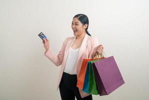 Asian woman holding shopping bag and credit card photo