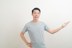 Asian man with hand pointing or presenting on white background photo