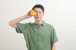 young Asian man holding credit card photo