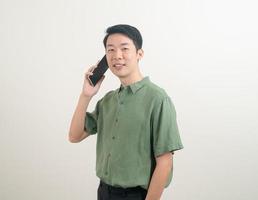 young Asian man using or talking smartphone and mobile phone photo