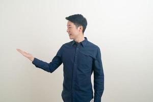 Asian man with hand pointing or presenting on white background photo